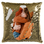 Qstomize.com - Personalize Your Pillow with Custom Reversible Sequin Design Gold sequin throw pillow depicting a joyful embrace between a woman and child in orange sweaters.