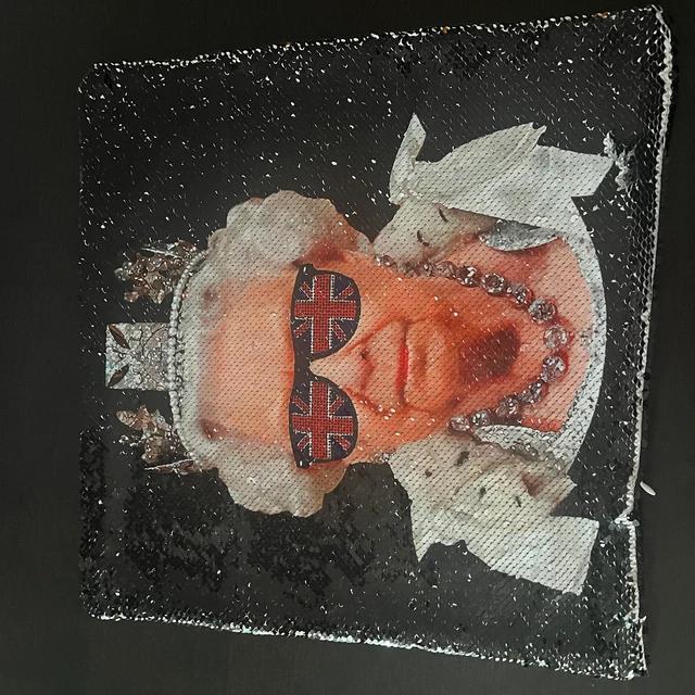 Qstomize.com - Personalize Your Pillow with Custom Reversible Sequin Design Elderly monarch in regal attire with Union Jack sunglasses, blending tradition and modern British culture.